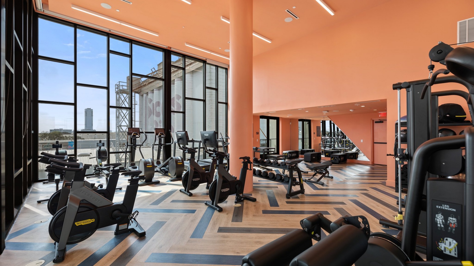 Large fitness center with wood floors and plenty of equipment