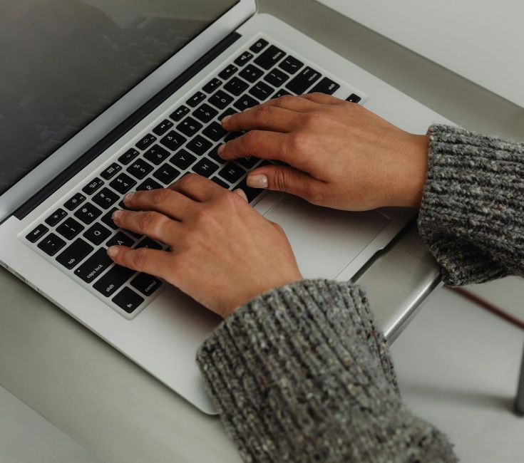 woman typing on laptop